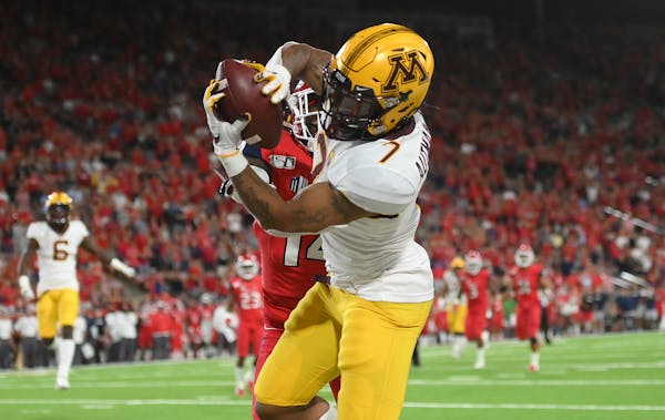 Gophers wide receiver Chris Autman-Bell (7) made a touchdown catch with less than a minute left in the fourth quarter to tie the game while being defe