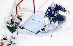 Minnesota Wild's Zach Parise (11) takes a shot on Vancouver Canucks goaltender Jacob Markstrom (25) during the second period of an NHL hockey playoff 