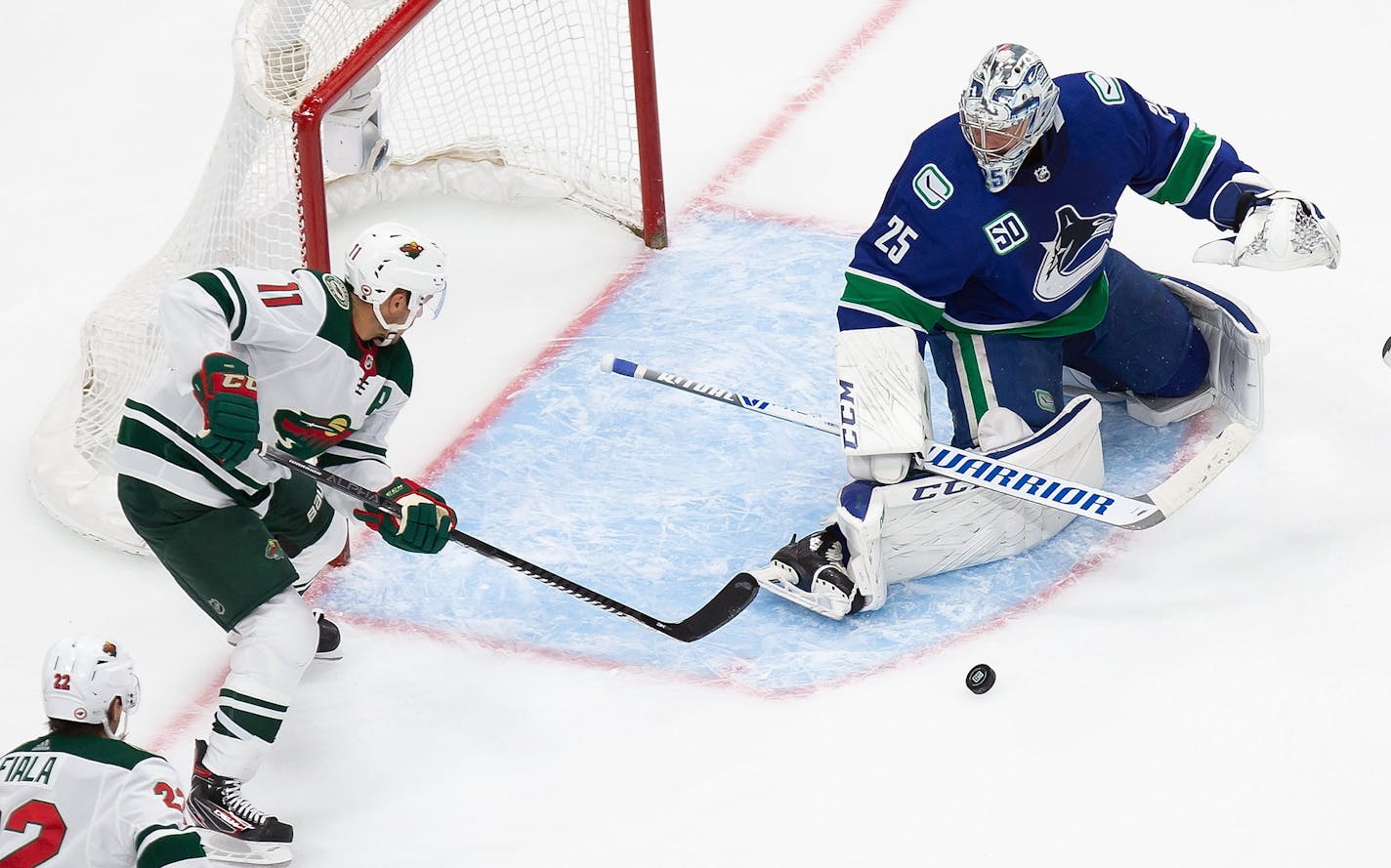 Minnesota Wild's Zach Parise (11) takes a shot on Vancouver Canucks goaltender Jacob Markstrom (25) during the second period of an NHL hockey playoff game in Edmonton, Alberta, Tuesday, Aug. 4, 2020. (Codie McLachlan/The Canadian Press via AP)