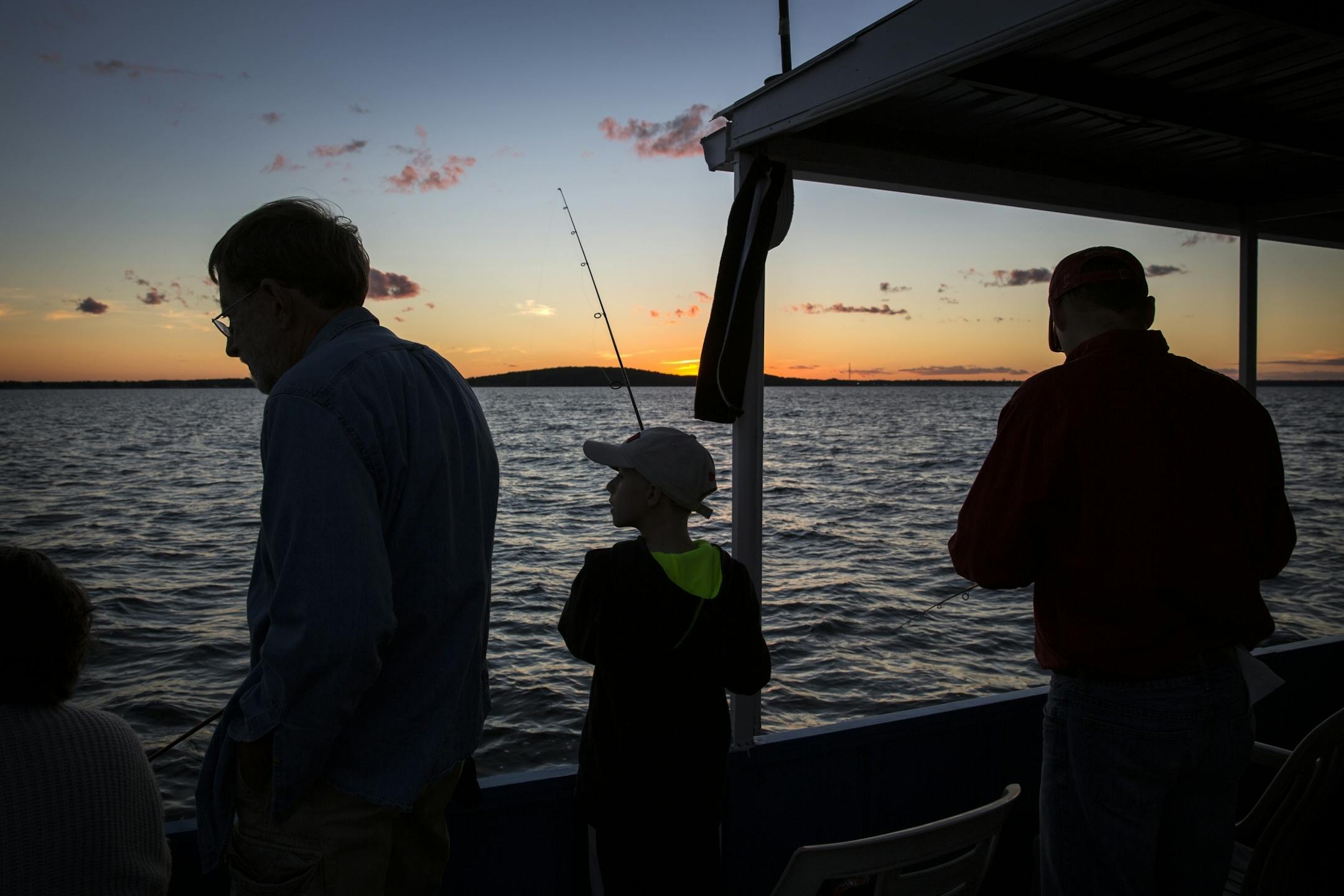 Customers fish during a fishing expedition with Twin Pines Resort on Mille Lacs Lake Monday, August 3, 2015.