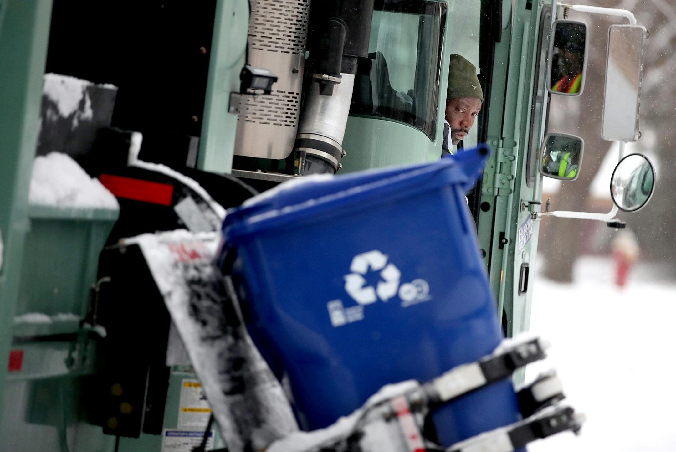 Driver Mourssalou Boukari made a recycling round early Wednesday, January 25, 2017 in St. Paul. The first couple of weeks with new recycling trucks, 80,000 new recycling bins and new recycling pickup days has been frustrating for thousands of St. Paul residents.