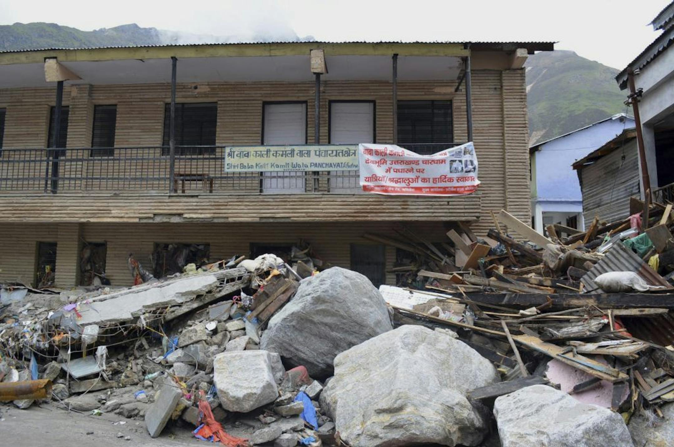 In this Thursday June 20, 2013, photo, damaged buildings are seen following heavy monsoon rains at Kedarnath, in the northern Indian state of Uttrakhand.
