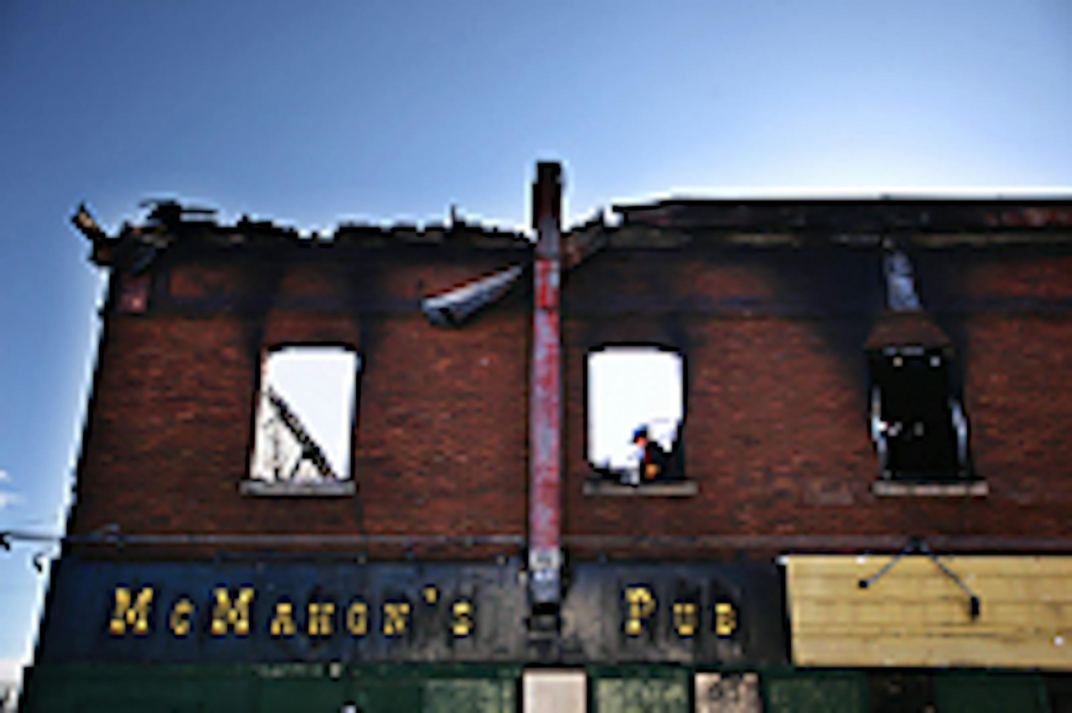 Fire investigators at the gutted McMahon's Pub last week.