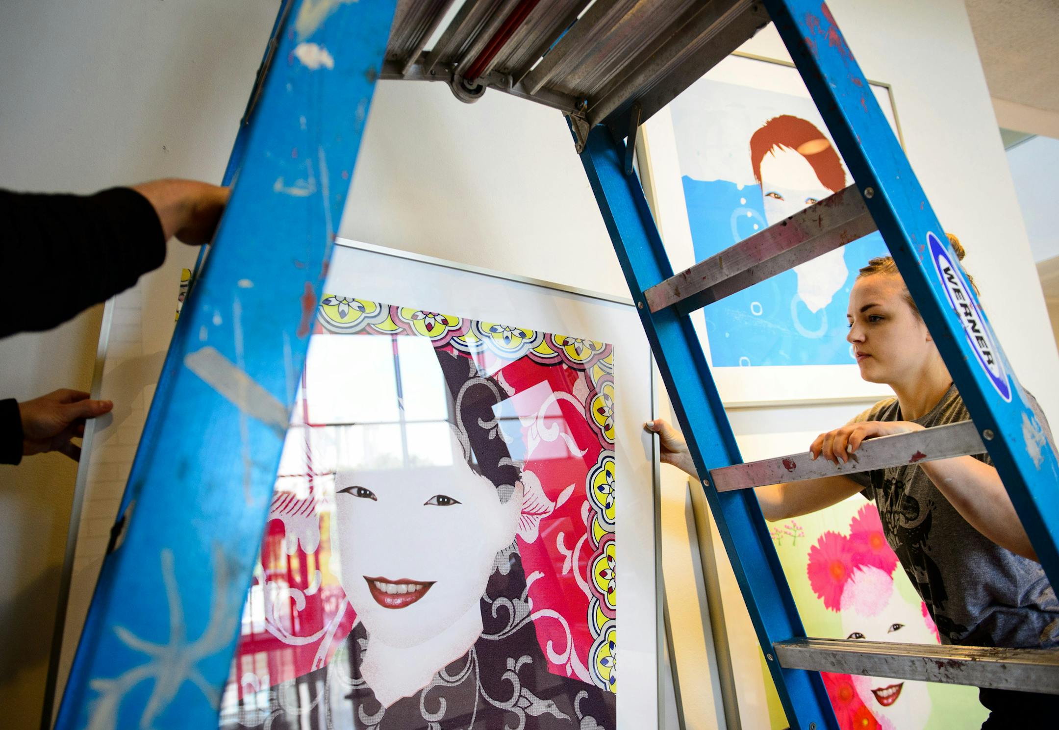 Sheila Wagner helped hang Tom Garrett&#x2019;s China With Love &#x2013; Pattern, for the Minneapolis College of Art and Design auction.