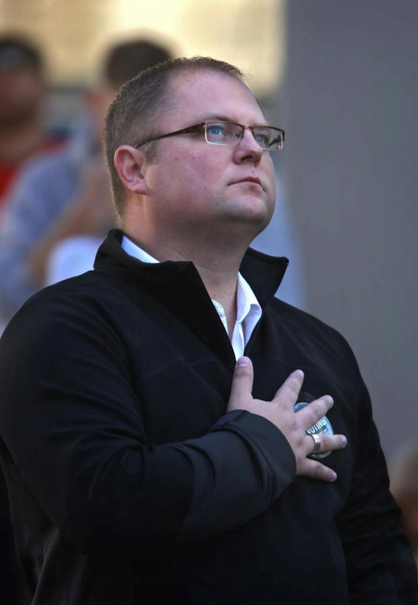 Richard Carlbom stood at attention during the playing of the National Anthem before the start of the Big Gay Race in Minneapolis in October 2012.