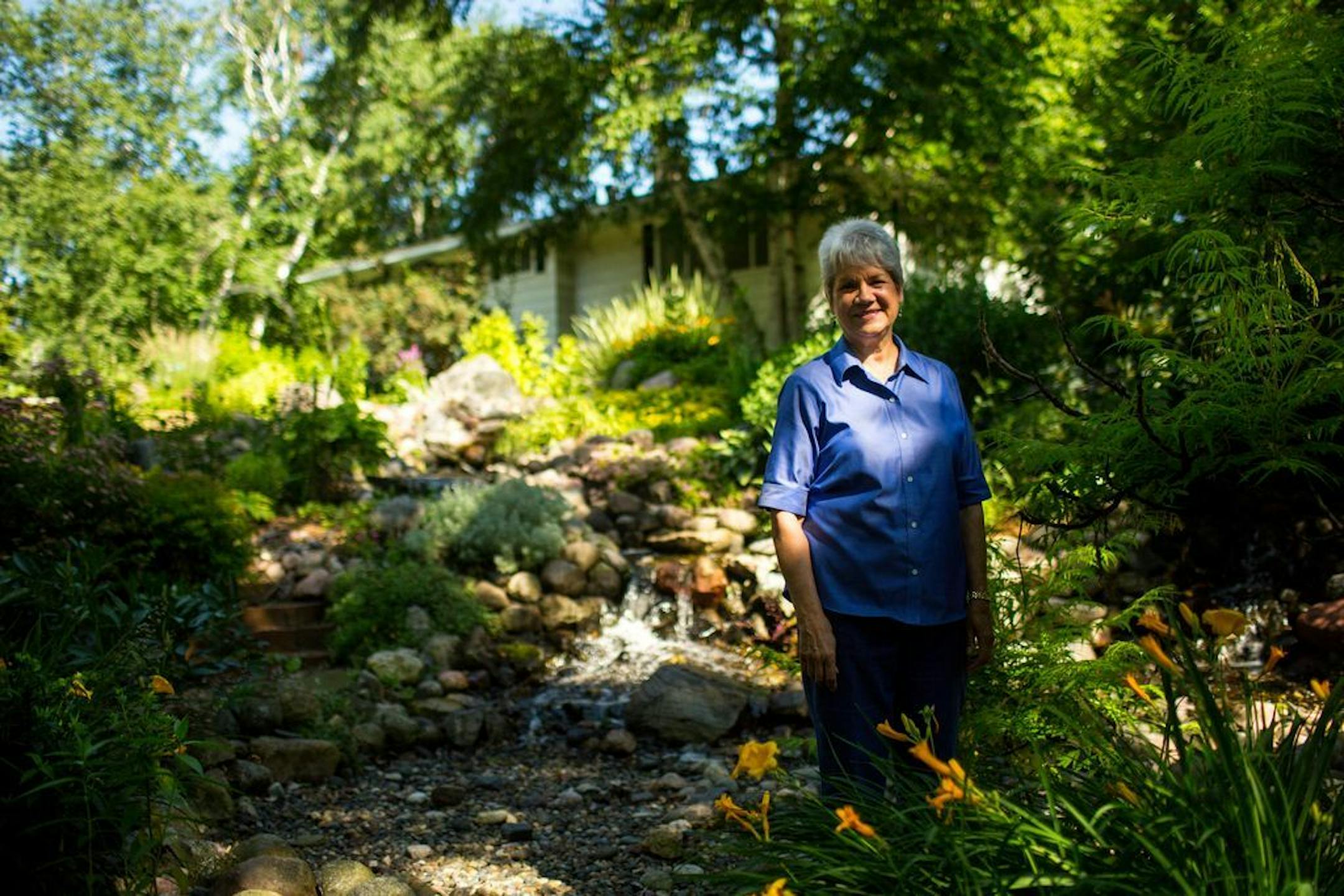 Candace McClenahan transformed her backyard hillside into an oasis of flowing water and perennial gardens
