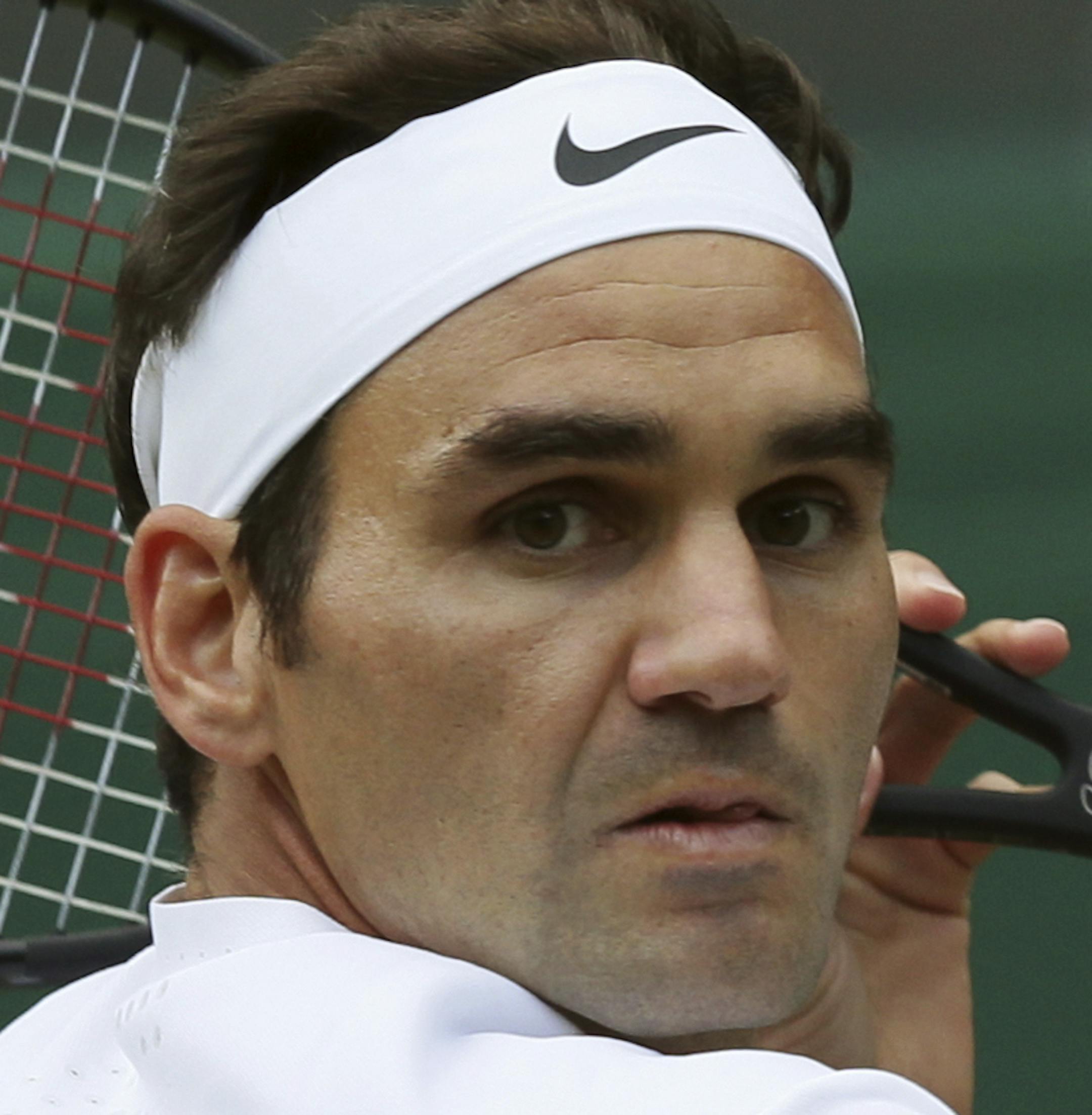 Switzerland's Roger Federer returns to Canada's Milos Raonic during their Men's Singles Quarterfinal Match on day nine at the Wimbledon Tennis Championships in London Wednesday, July 12, 2017. (AP Photo/Tim Ireland)