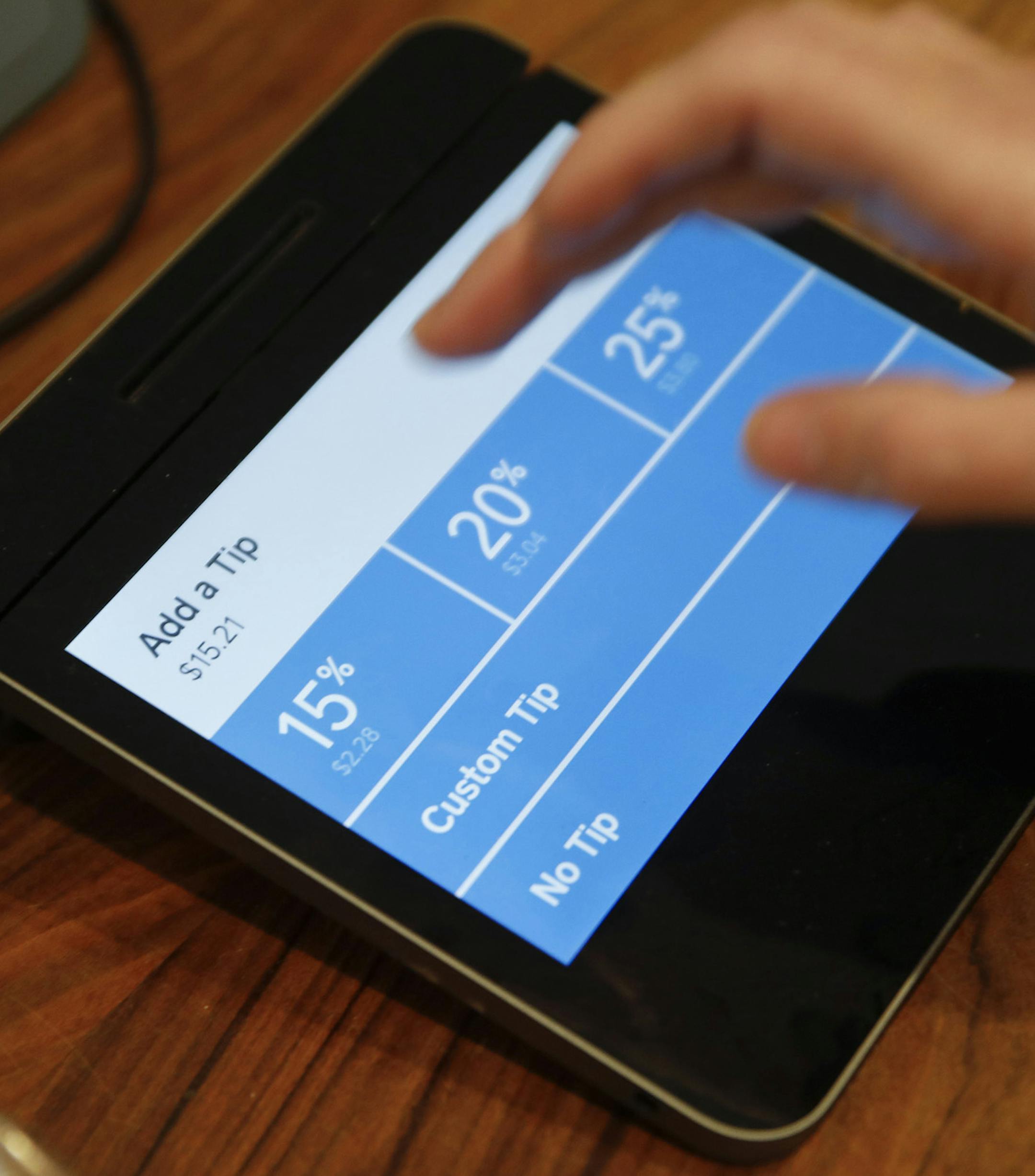 Christine Wickes, of Chicago, uses the technology to check out and then adds a tip at a Dollop coffee shop in the Streeterville neighborhood in Chicago (860 N. Dewitt Place) on Thursday, Nov. 29, 2018. The story is about how technology is transforming tipping, perhaps most evident when people swipe their credit cards at coffee shops and are confronted with a tip screen prompting them to add a tip for a service they may not have considered tipping for before. (Jose M. Osorio/Chicago Tribune) ORG