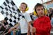 Brothers Dylan, 9, left, and Mason Raaen, 7, of New Prague, cheer on the drivers during the "Pack the Stands" event at Raceway Park in Shakopee, Minn.