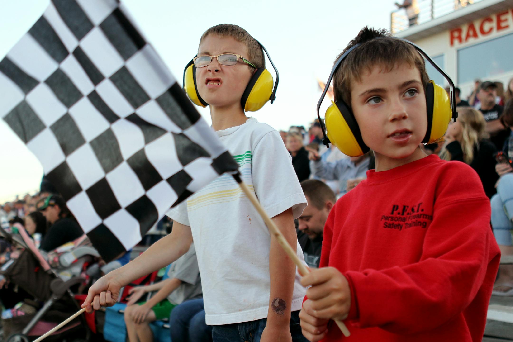 Brothers Dylan, 9, left, and Mason Raaen, 7, of New Prague, cheer on the drivers during the "Pack the Stands" event at Raceway Park in Shakopee, Minn., on Sunday, August 4, 2013. ] (ANNA REED/STAR TRIBUNE) anna.reed@startribune.com (cq)