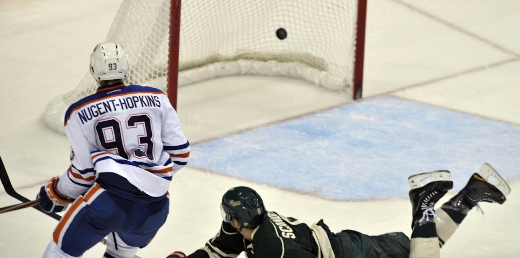 Edmonton Oilers' Ryan Nugent-Hopkins (93) gets an empty net goal as Minnesota Wild's Marco Scandella, right, attempts to make the stop during the third period of an NHL hockey game Friday, Nov. 25, 2011, in St. Paul, Minn. Edmonton won 5-2.