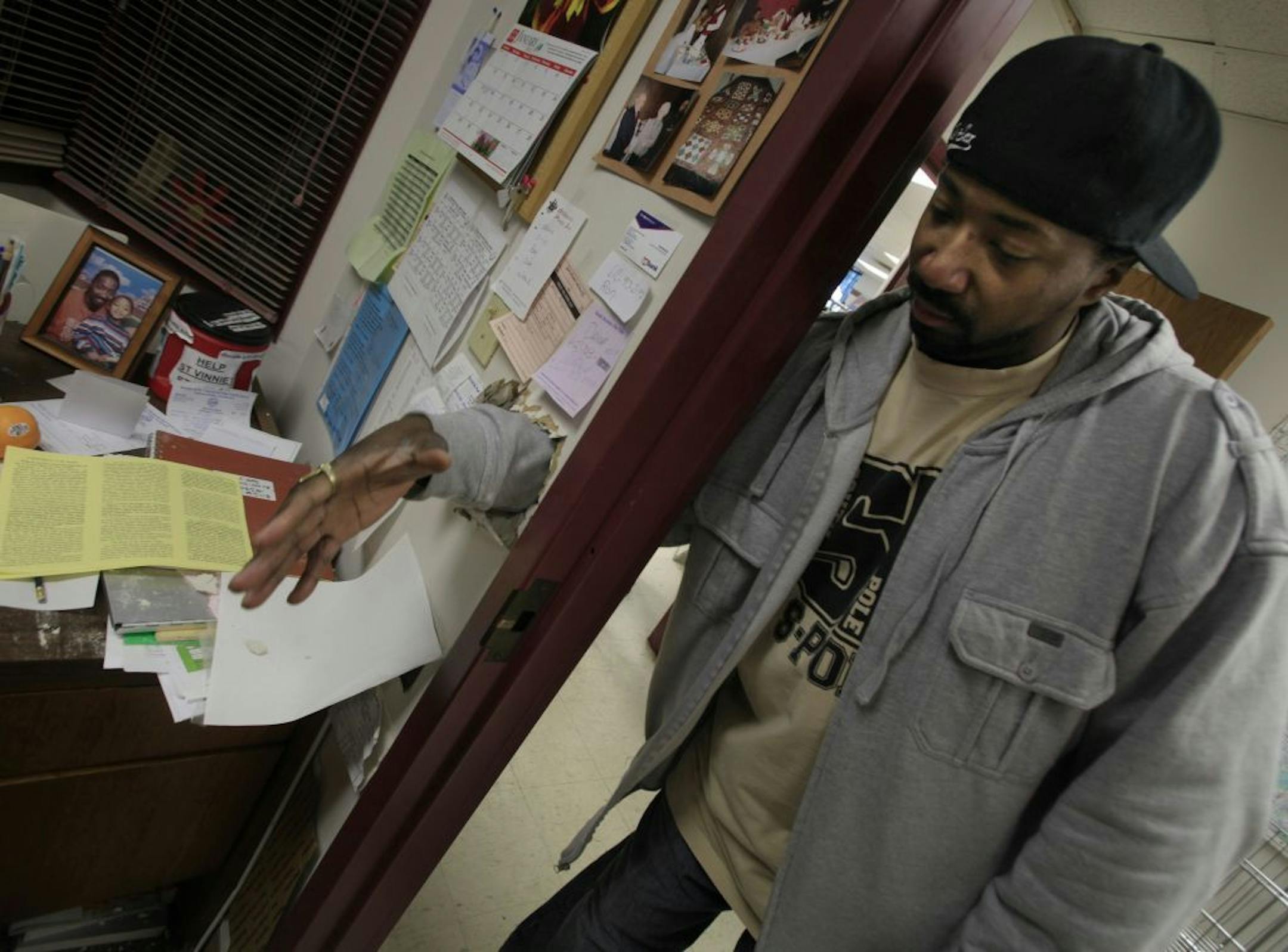 Store Manager Waynne Bugg from the Society of St. Vincent de Paul Thrift store reached his hand thru the hole that was made by the robbers that stole around $1000 cash along with the safe which weighed around 100 pounds. The safe and and cameras was located in his locked office when the breakin occurred around 3:18 am on Sunday morning January 29th 2012. The security tape was also taken out of his office and finger prints was taken from the scene by police.