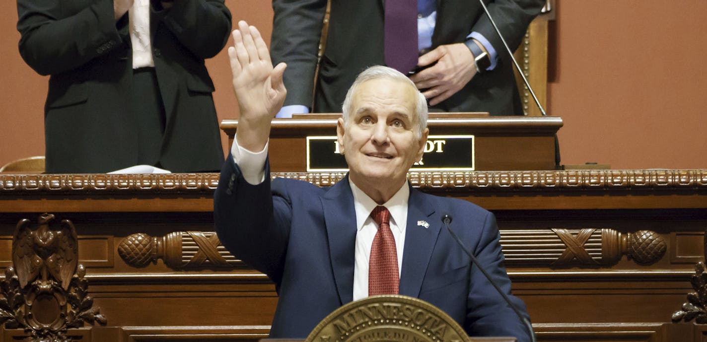 Minnesota Governor Mark Dayton waves and smiles at his family in the House Gallery in St. Paul, Minn., Wednesday, March 14, 2018, during his final State of the State address. Behind him are Lt. Governor and Senate President Michelle Fischbach and House Speaker Kurt Daudt. (Glen Stubbe/Star Tribune via AP)