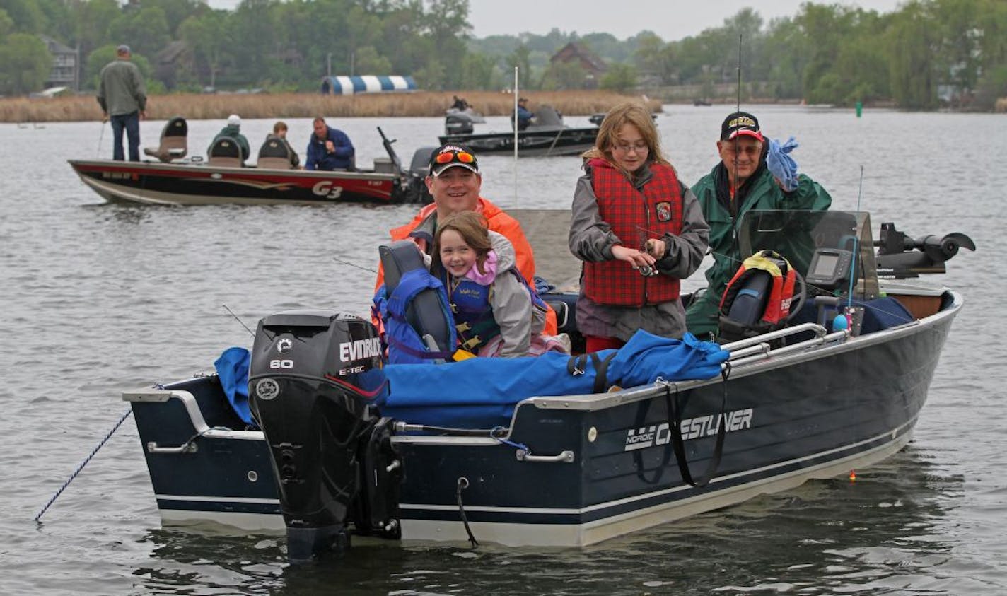 (left to right) Darren Heimbuch, Mary Heimbuch age-6, Katherin Heimbuch age-9, and Barry Heimbuch (grandfather), from Debuque IA, fished in Seaton Lake/Lake Minnetonka in the Minnesota Bound's Crappie Contest. The family is formerly from Minnesota and and fished in the contest the past 30 years. Under sponsorship by Ron Schara's Minnesota Bound television show, the contest pre-registered over 1000 anglers for the event based out of Lord Fletcher's on Lake Minnetonka, 5/5/12.