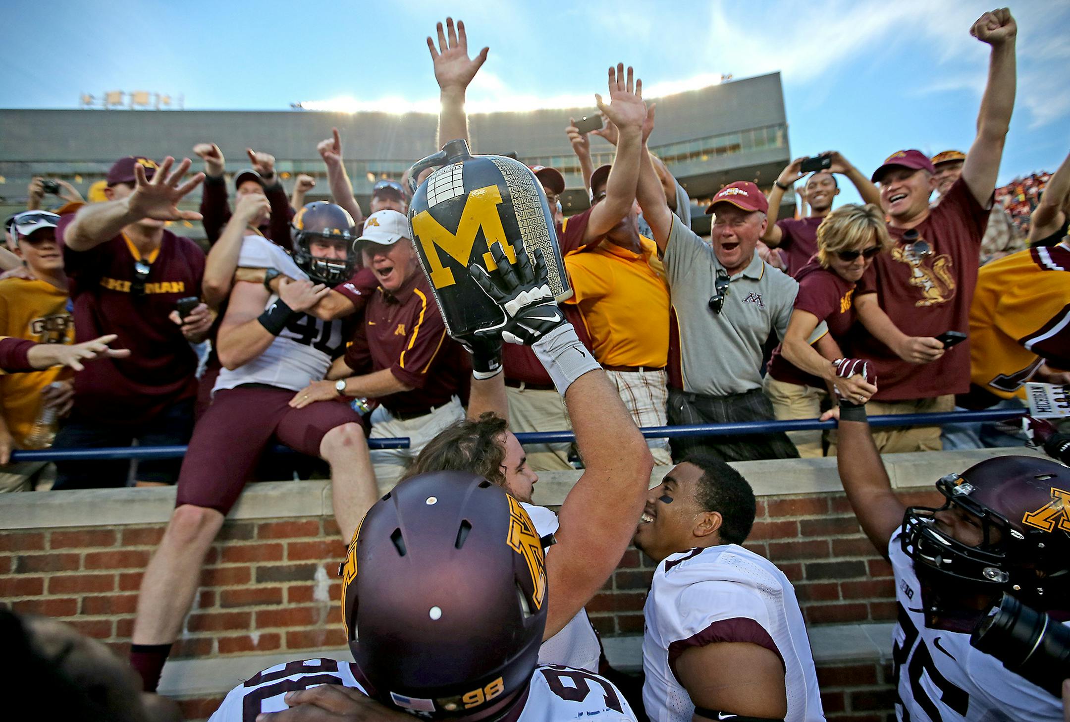 Minnesota Gopher players and fans celebrated with the Little Brown Jug after defeating Michigan 30-14 at Michigan Stadium, Saturday, September 27, 2014 in Ann Arbor, MI. ] (ELIZABETH FLORES/STAR TRIBUNE) ELIZABETH FLORES • eflores@startribune.com ORG XMIT: MIN1409271829560266