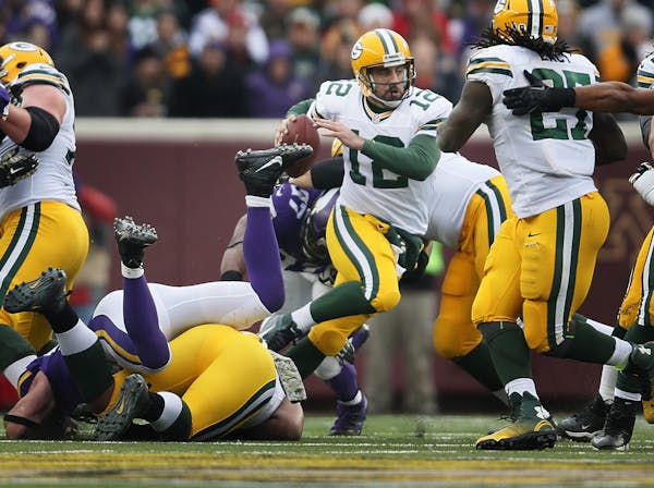 Green Bay Packers quarterback Aaron Rodgers (12) was forced out of the pocket in the second half Sunday November 23, 2014 in Minneapolis , Minnesota.