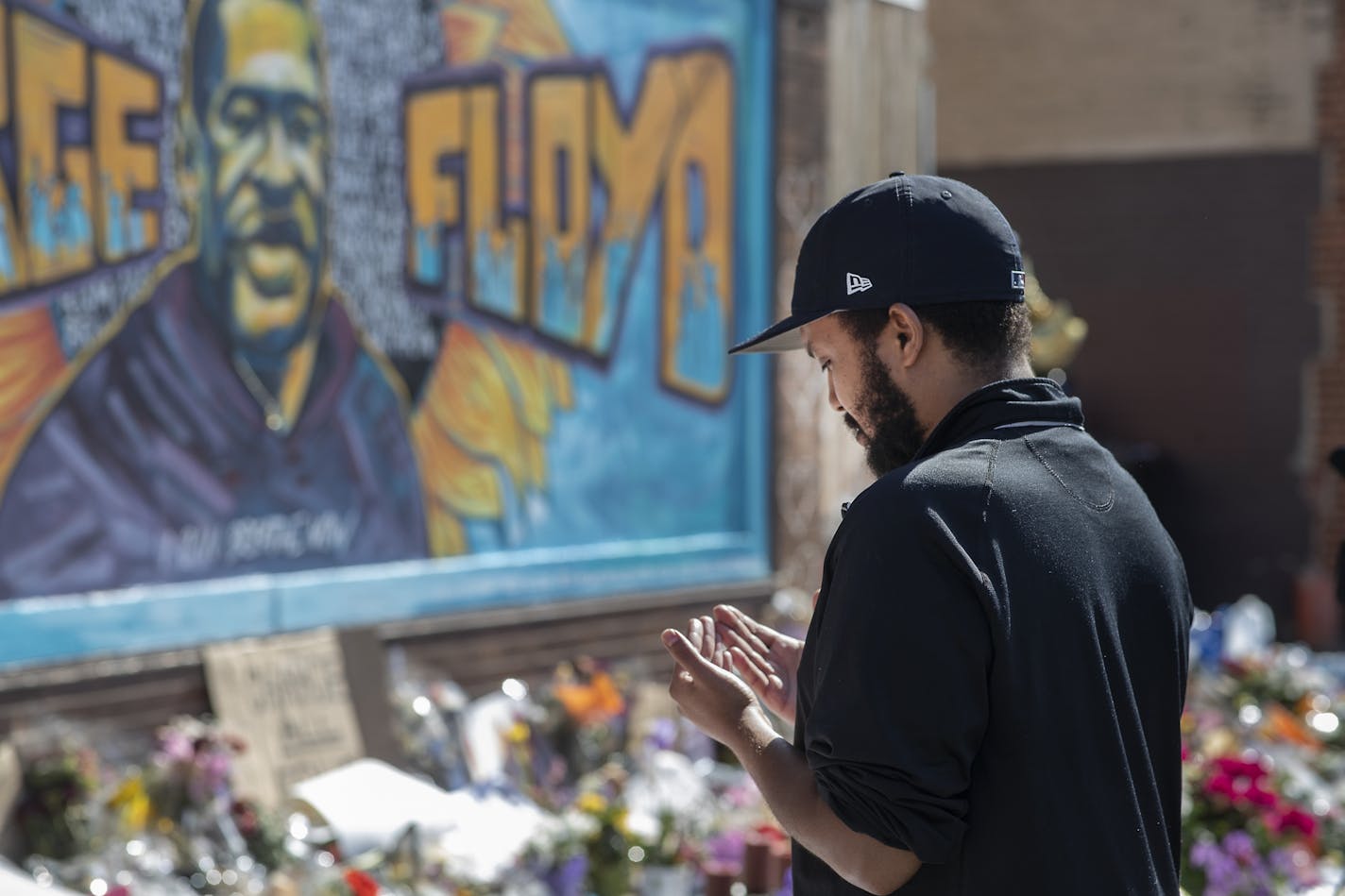 Mohamed Ali showed his respect with a prayer on Sunday, May 31, 2020, at Cup Foods in Minneapolis where George Floyd was killed by a Minneapolis police officer.