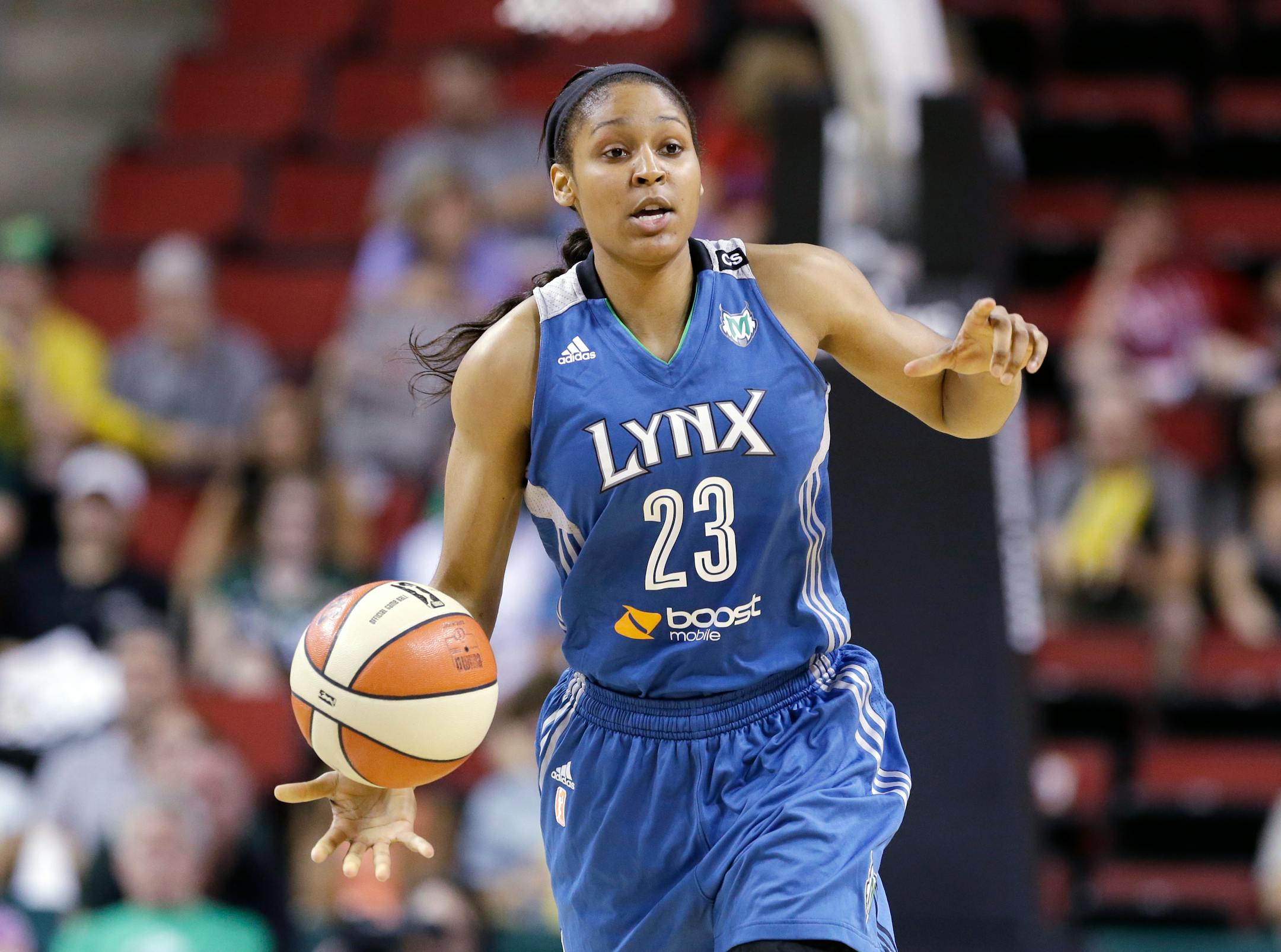 Minnesota Lynx's Maya Moore in action against the Seattle Storm in the first half of a WNBA basketball game Tuesday, Sept. 10, 2013, in Seattle. (AP Photo/Elaine Thompson)