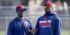Butch Davis (left, with Miguel Sano) will not be back as first base coach with the Twins in 2017. Hitting coach Tom Brunansky also was let go.