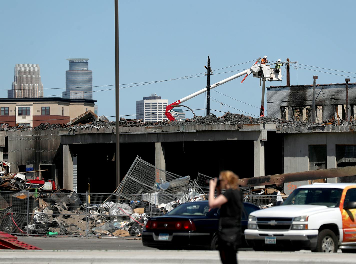 Utility workers put up new power poles and lines just north of Lake Street near 26th Ave. S. After some power poles were destroyed during unrest last week in the wake of the Minneapolis police killing of George Floyd in police custody and seen Friday, June 5, 2020 in Minneapolis, MN.] DAVID JOLES • david.joles@startribune.com Ongoing coverage of George Floyd death and aftermath.