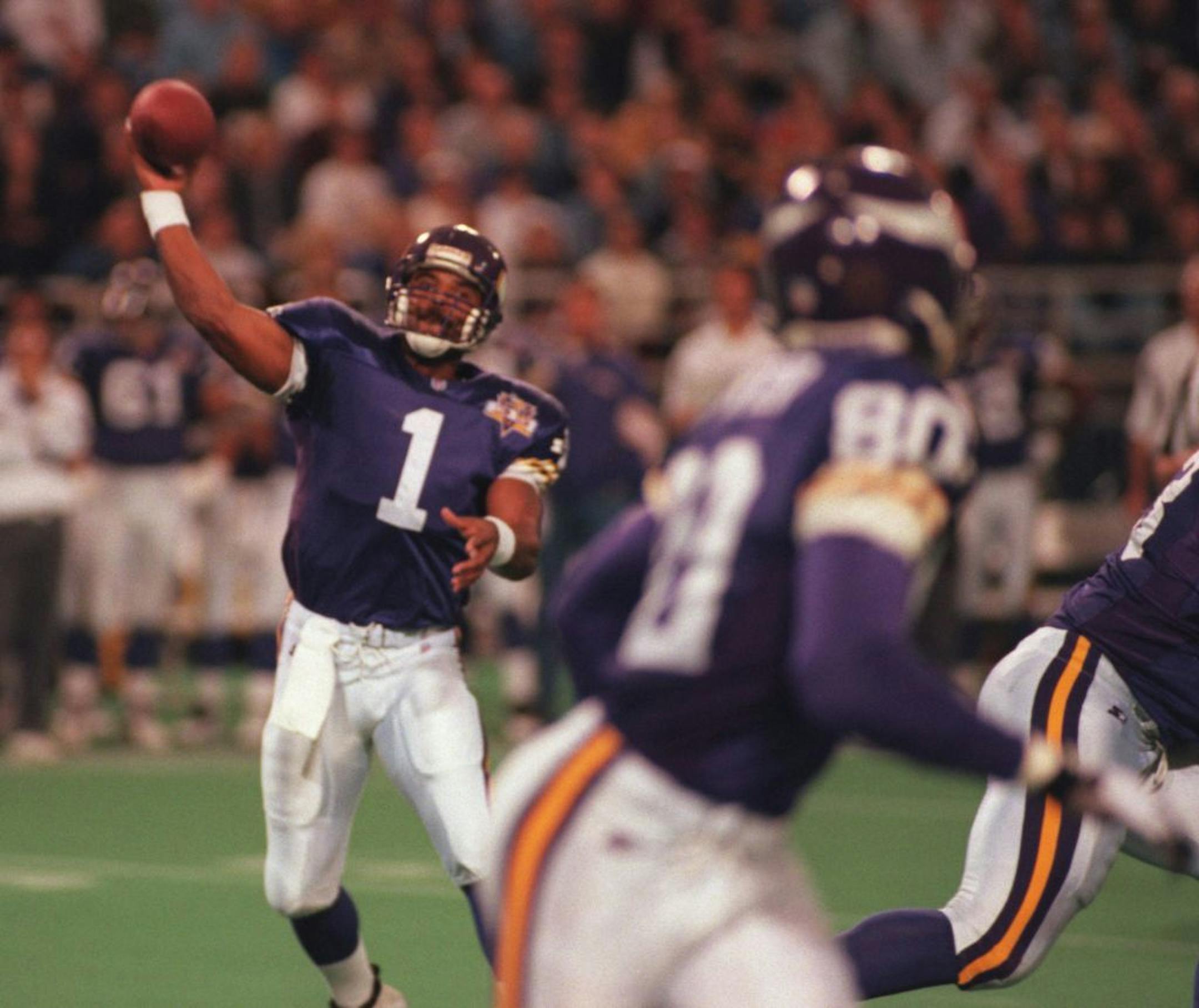 Quaterback Warren Moon throws a pass to his favorite receiver, #80 Cris Carter...