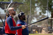 Twins manager Rocco Baldelli, left, and third base coach Tommy Watkins watched players stretch during spring training at Hammond Stadium in Fort Myers