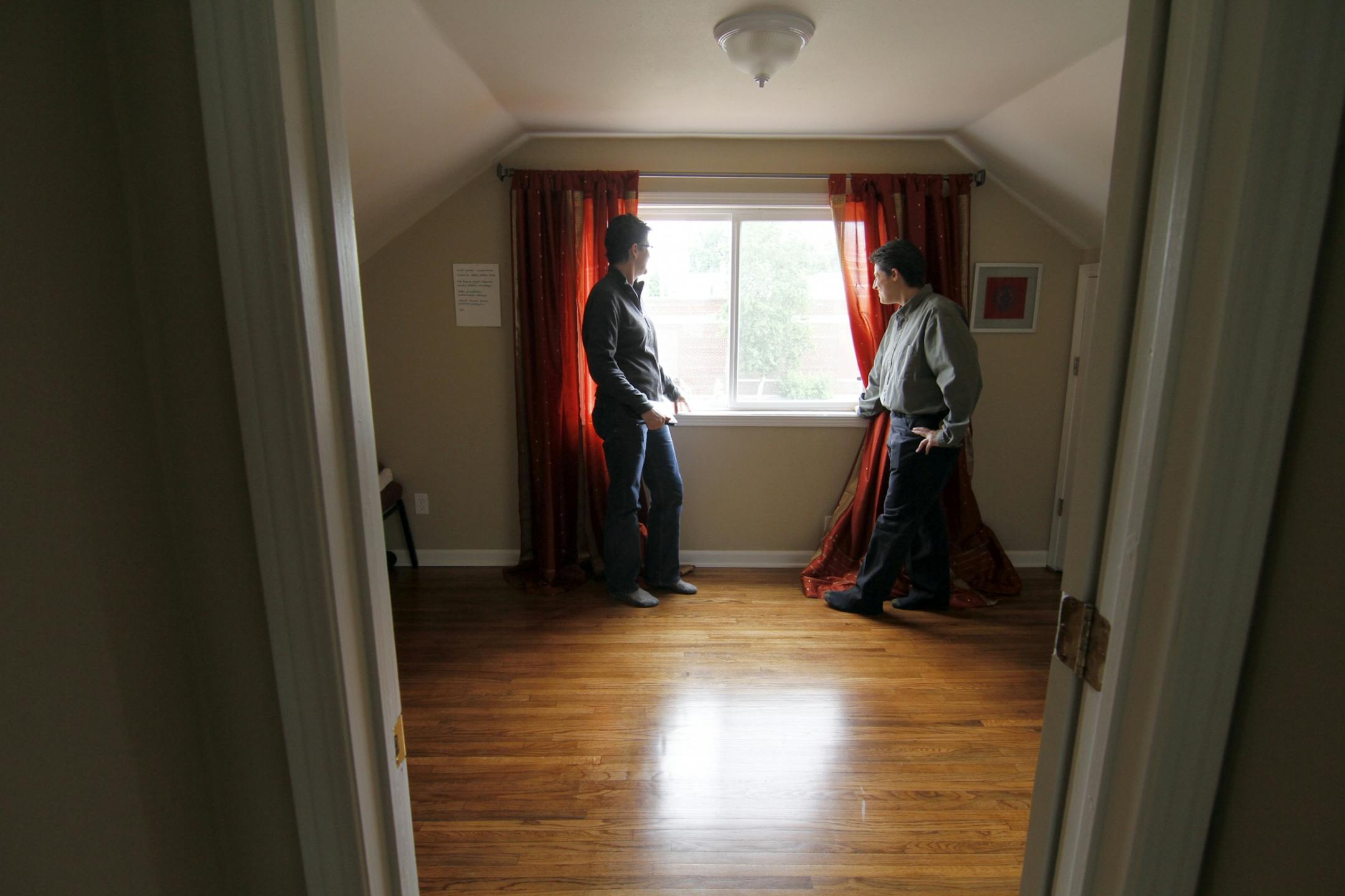 Derryn Grey ( left) and realtor Amy Ruzick ( right) checked the view from an upper level window of a home they toured in the Powderhorn neighborhood.