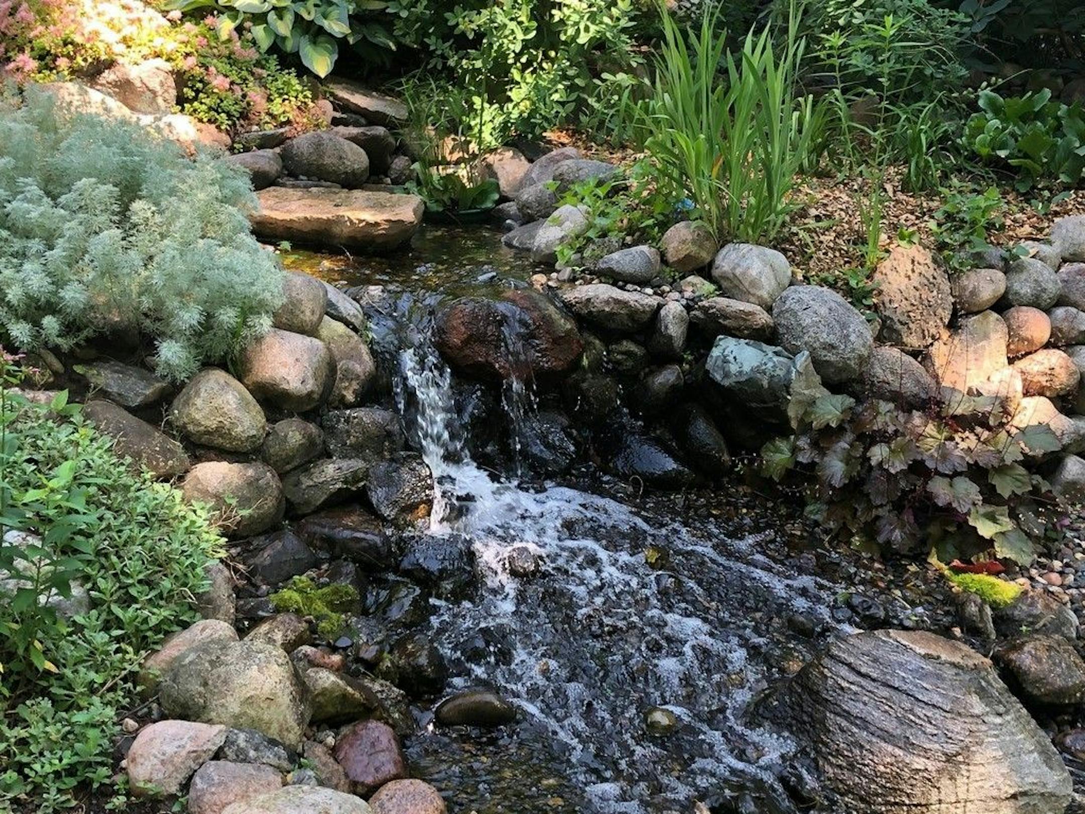 Gardener Candace McClenahan designed the perennial gardens and handpicked and placed all the rocks.