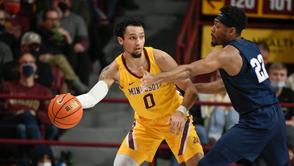 Minnesota guard Payton Willis, left, looks to pass around Penn State guard Jalen Pickett during the second half an NCAA college basketball game Saturd