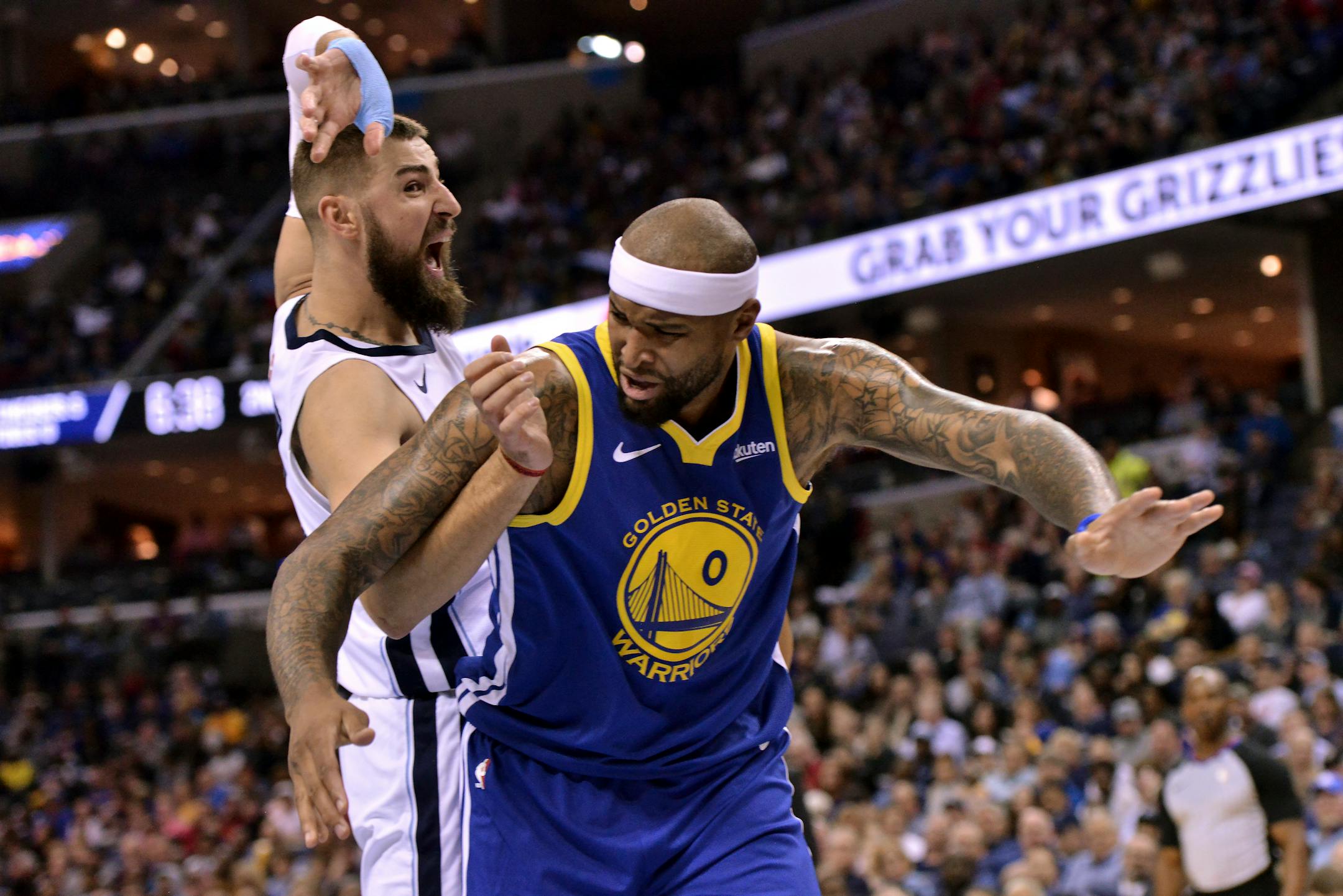 Golden State Warriors center DeMarcus Cousins (0) and Memphis Grizzlies center Jonas Valanciunas struggle for position in the first half an NBA basketball game Wednesday, March 27, 2019, in Memphis, Tenn. (AP Photo/Brandon Dill)