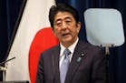 Japanese Prime Minister Shinzo Abe delivers a statement to mark the 70th anniversary of the end of World War II during a press conference at his offic