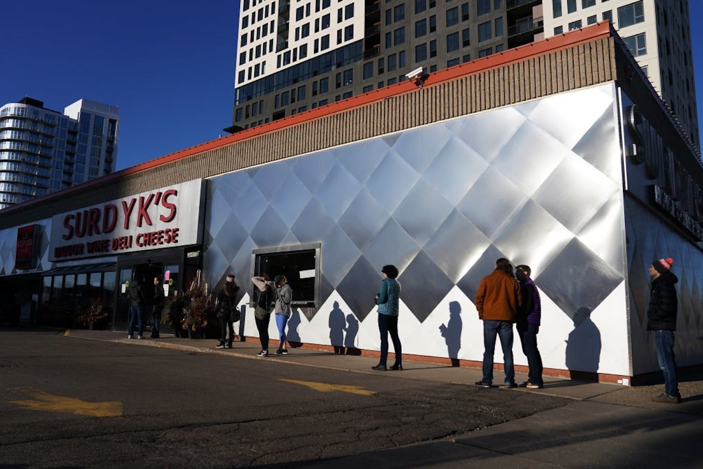 A line of socially distant customers formed Friday outside of Surdyk's on Hennepin Avenue in Minneapolis as they limited how many customers could be in at one time because of the coronavirus pandemic.