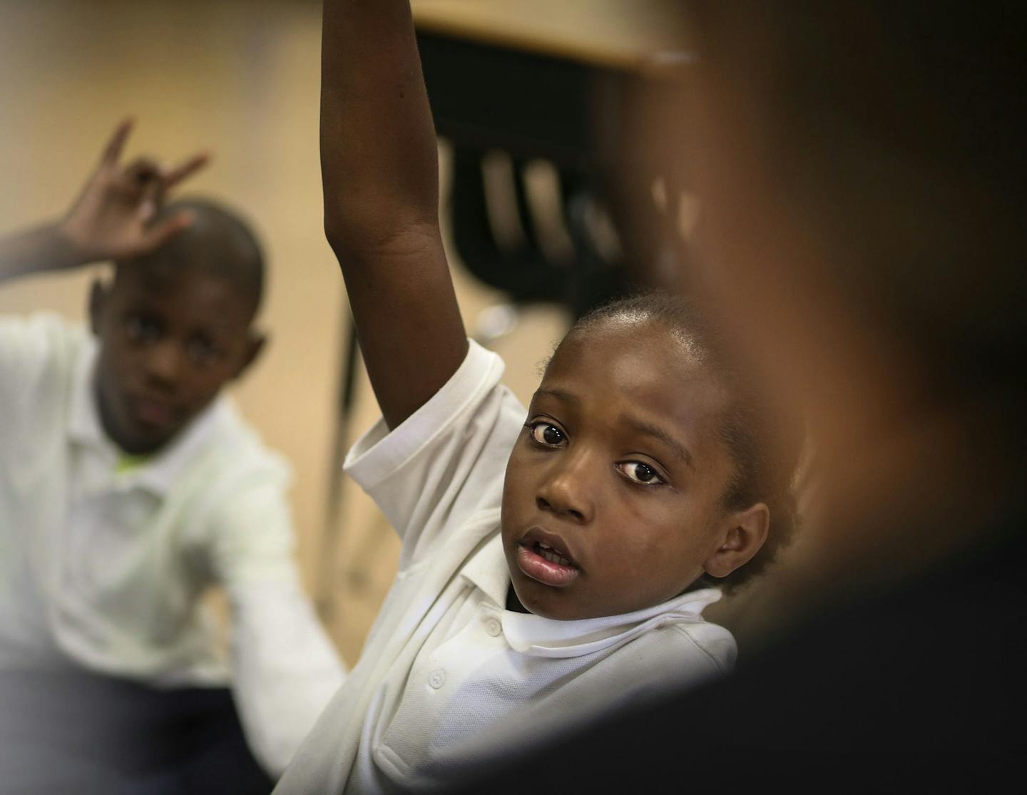 Fifth graders at Lucy Laney Community School have had a boost in math test scores from having two teachers and were seen Thursday Aug. 28, 2014, in Minneapolis MN. Here, fifth grader Marquese Ross raises his hand to answer a math question posed by teacher Nicole Plowman.] (DAVID JOLES/STARTRIBUNE)djoles@startribune.com No seventh grader at Lucy Laney communtiy school met state reading standards last year. According to MCA scores, seventh grade reading proficiency tanked from 10 percent to 0 in j