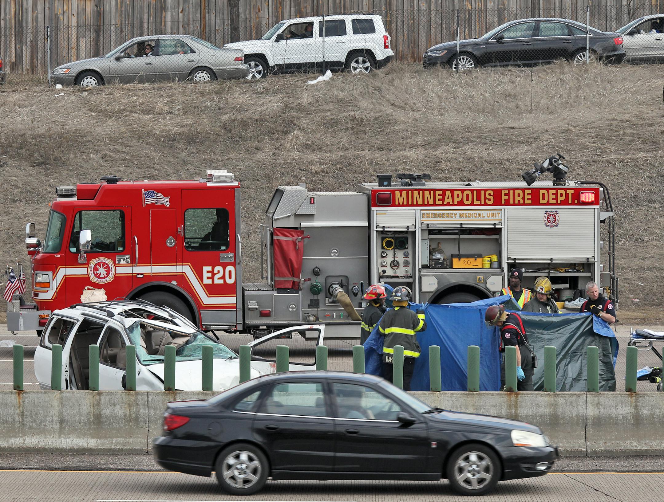 Multiple fatality roll-over accident on I-94 and 49th street in Minneapolis. First responders held up tarps around bodies near the roll-over van.
