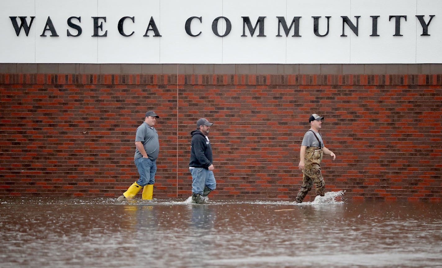 City employees assessed the flood damage Thursday morning around the Waseca Community Arena in Waseca.