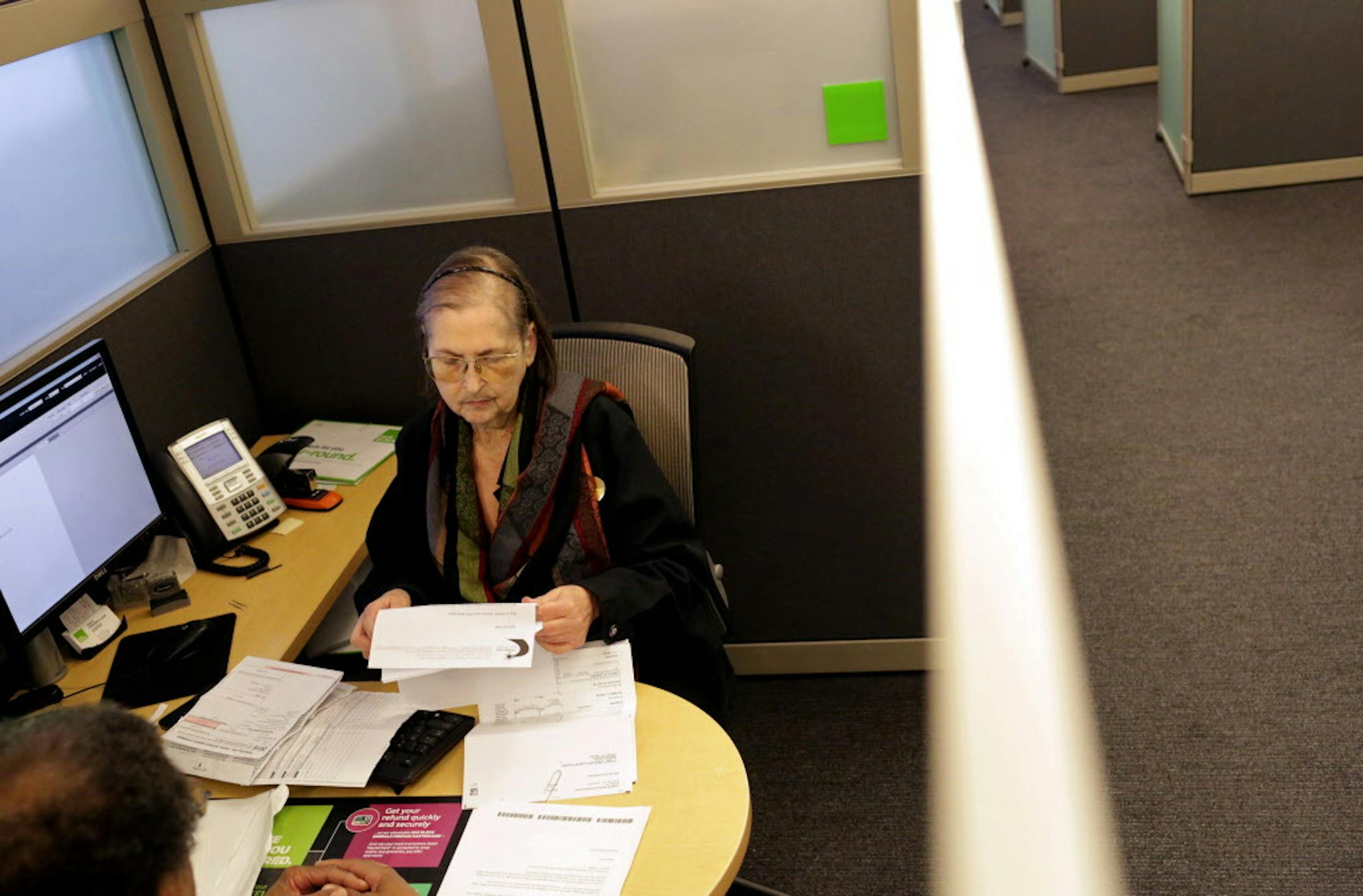 Lois Horowitz, senior tax consultant with H&R Block in Manhattan, checks out a client's tax documents during an appointment in New York, Jan. 31, 2017. The I.R.S. makes it easy to use your refund to buy savings bonds or to divide your refund among various bank accounts, rather than spending it all at once. (Yana Paskova/The New York Times)