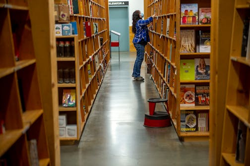 A shopper at the flagship PowellÕs Books store in Portland, Oregon, on Nov. 2, 2021. Like the rest of PortlandÕs urban core Ñ and like downtowns across the United States ÑPowellÕs Books is contending with staggering uncertainty. (Amanda Lucier/The New York Times)