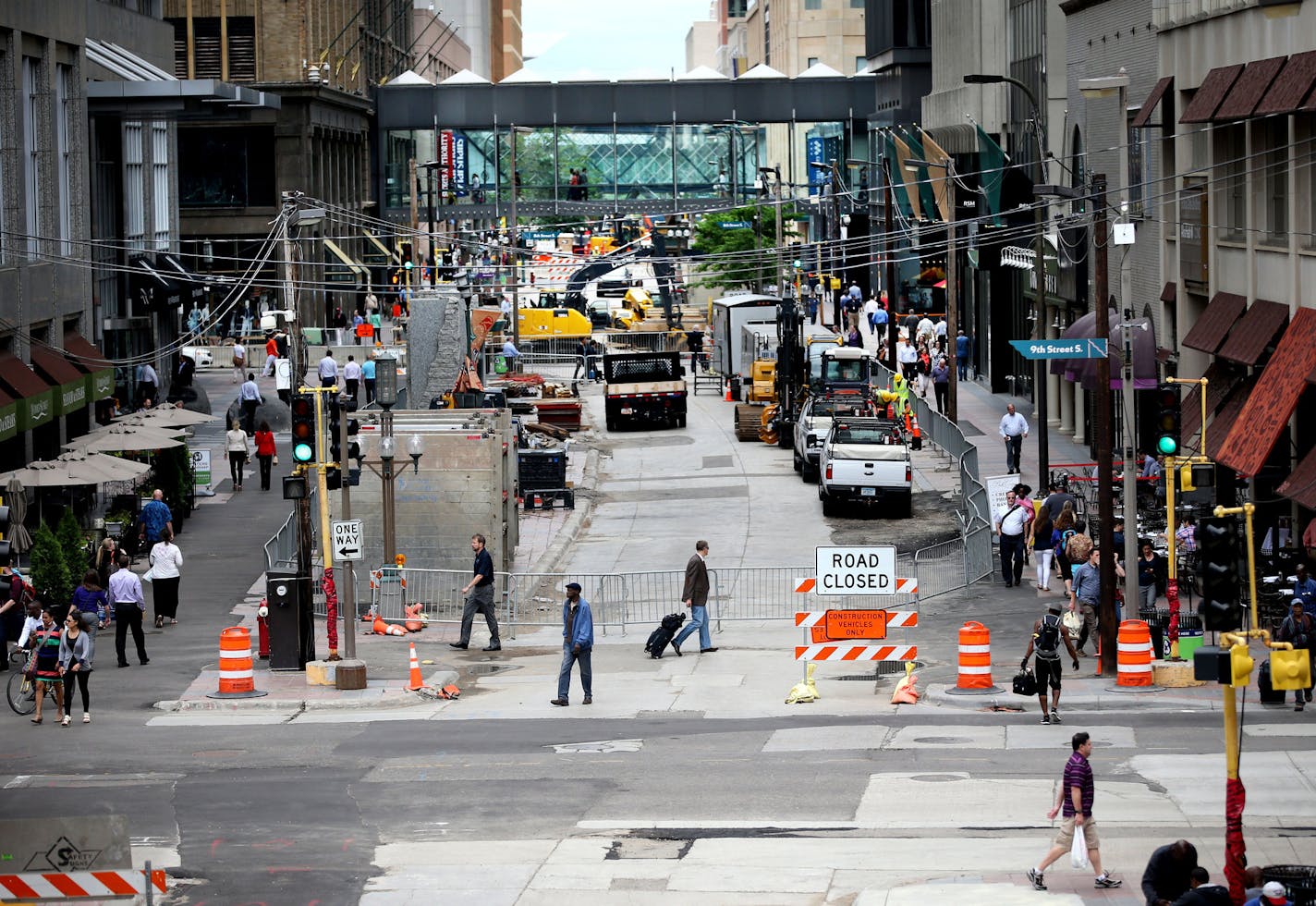 Officials announced a new phase of the Niciollet Mall Reconstruction with a block-by-block deconstruction of the streets , followed by the installment of new sidewalks and roadways during a press conference outside the IDS Building Wednesday, June 15, 2016, in Minneapolis, MN. Here, seen from a Target skyway, pedestrians cross Nicollet near 8th St. on patched asphalt, with a new underground infrastructure in place.](DAVID JOLES/STARTRIBUNE)djoles@startribune Mayor Hodges and downtown leaders are