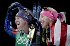 United States' Jessie Diggins, left, and Kikkan Randall celebrate after winning the gold medal in the women's team sprint freestyle cross-country skii