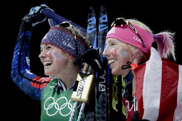 United States' Jessie Diggins, left, and Kikkan Randall celebrate after winning the gold medal in the women's team sprint freestyle cross-country skii