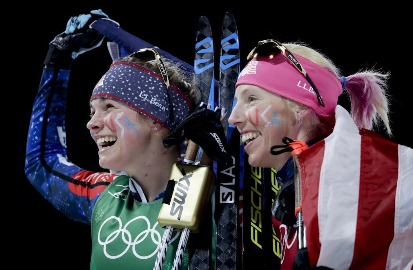 United States' Jessie Diggins, left, and Kikkan Randall celebrate after winning the gold medal in the women's team sprint freestyle cross-country skiing final at the 2018 Winter Olympics.