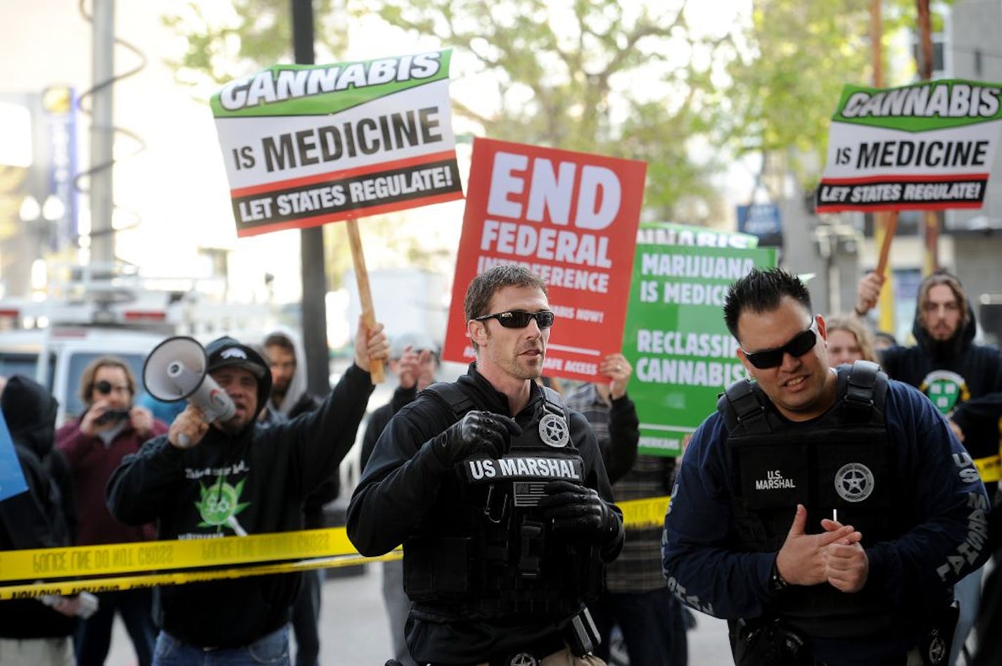 April 2012: With marijuana proponents chanting behind them, U.S. marshals raid Oaksterdam University in Oakland, Calif., on Monday, April 2, 2012.