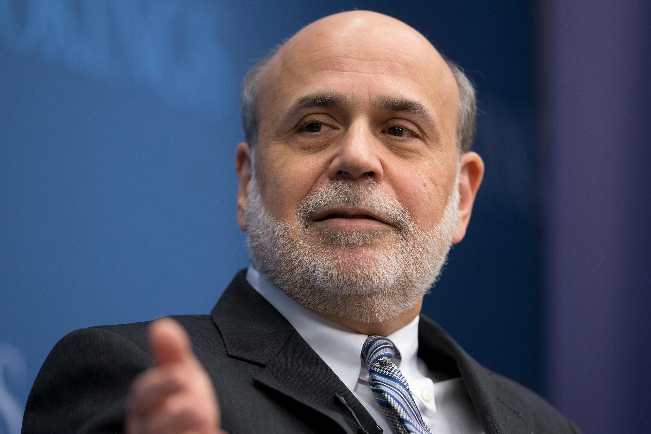 Ben S. Bernanke, chairman of the U.S. Federal Reserve, speaks during a discussion at the Brookings Institution in Washington, D.C., U.S., on Thursday, Jan. 16, 2014. Bernanke defended quantitative easing, saying it has helped the economy while posing little risk of inflation. Photographer: Andrew Harrer/Bloomberg *** Local Caption *** Ben S. Bernanke
