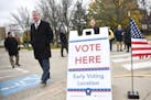 St. Paul Mayor Chris Coleman, left, walked into the Martin Luther King Recreation Center to cast his early vote Tuesday afternoon. ] AARON LAVINSKY &#