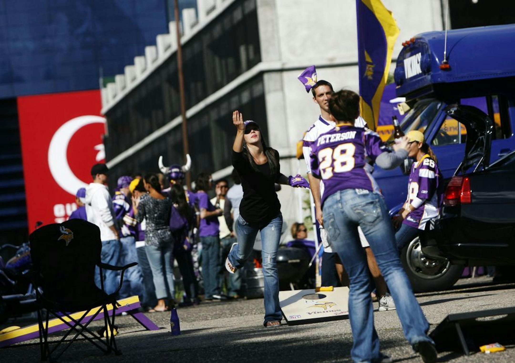 Minnesota Vikings fans enjoy a game of bean bag toss while tailgating before the Vikings and Kansas City game at the Metrodome.