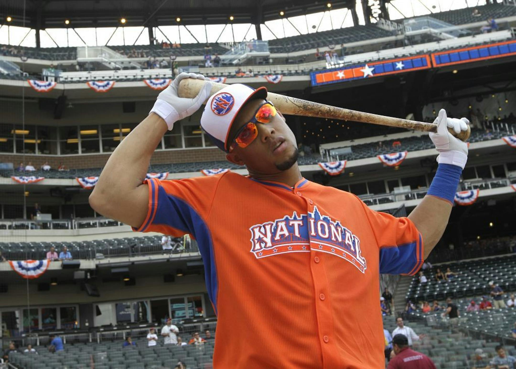 Carlos Gomez of the Milwaukee Brewers stretches during batting practice for the MLB All-Star baseball game, on Monday, July 15, 2013 in New York.