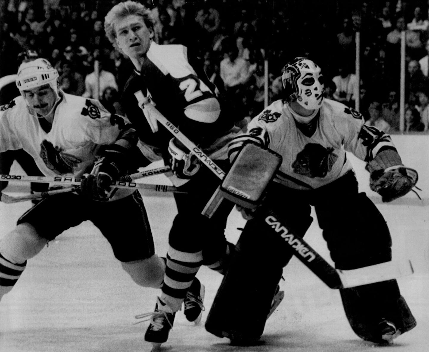 November 15, 1982 Chicago's Dave Feamster, left, Minnesota's Willi Plett and goalie Murray Bannerman watched the bouncing puck after Bannerman deflected a shot in the first period. Associated Press