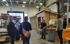 District Fundraising Coordinator Willie Spelts leads a tour of Rock Ridge High School, now in its second year of classes. The school was built by the