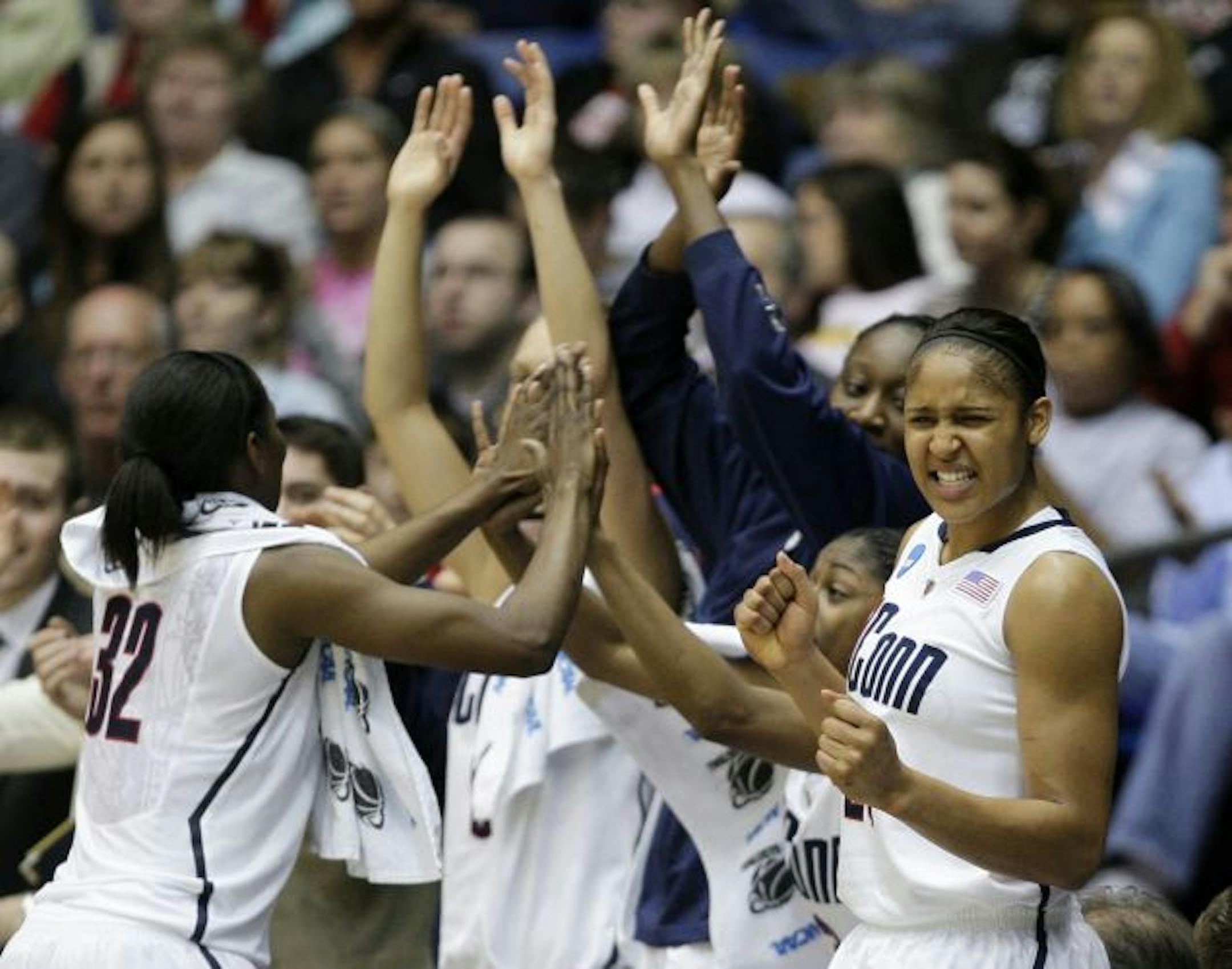 Maya Moore (right) and the Connecticut Huskies play for the national title Tuesday night, looking to extend a 77-game winning streak.