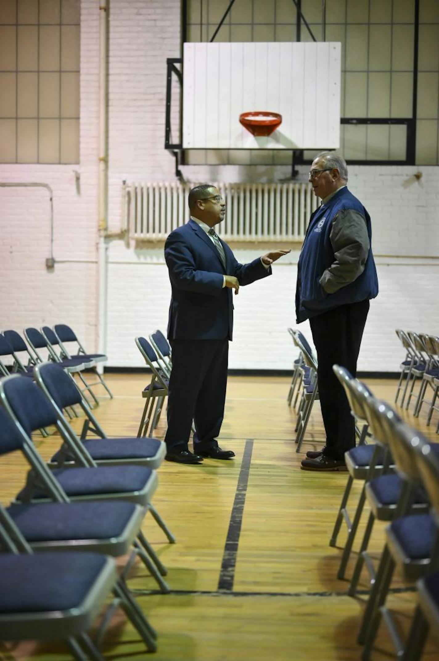 Minnesota Attorney General Keith Ellison spoke to Hennepin County Prosecutor Mike Freeman before the start of Thursday night's listening session at the Sabathani Community Center in Minneapolis.